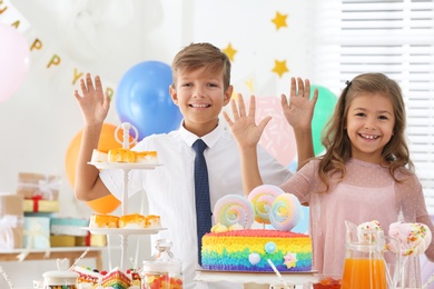 Photo of Happy children at birthday party in decorated room