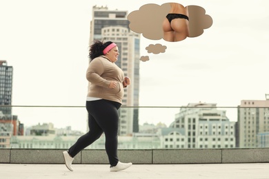 Motivated overweight woman dreaming about slim body while running outdoors. Weight loss concept