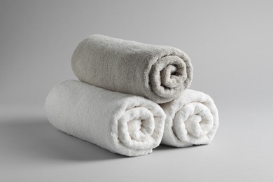 Fresh soft rolled towels on light background