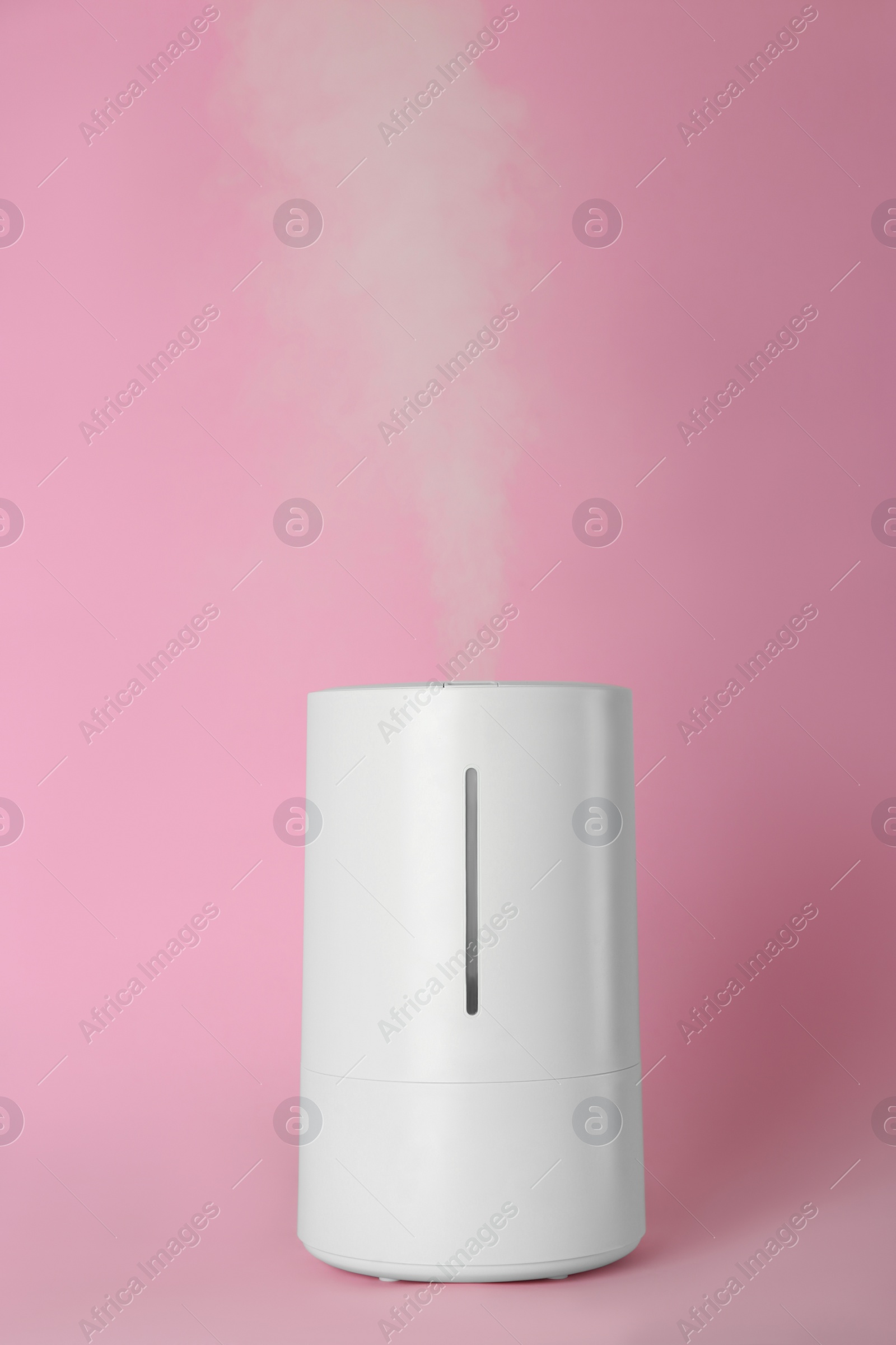 Photo of New modern air humidifier on pink background