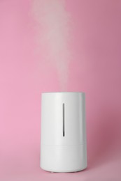 Photo of New modern air humidifier on pink background