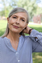 Photo of Portrait of beautiful smiling senior woman outdoors