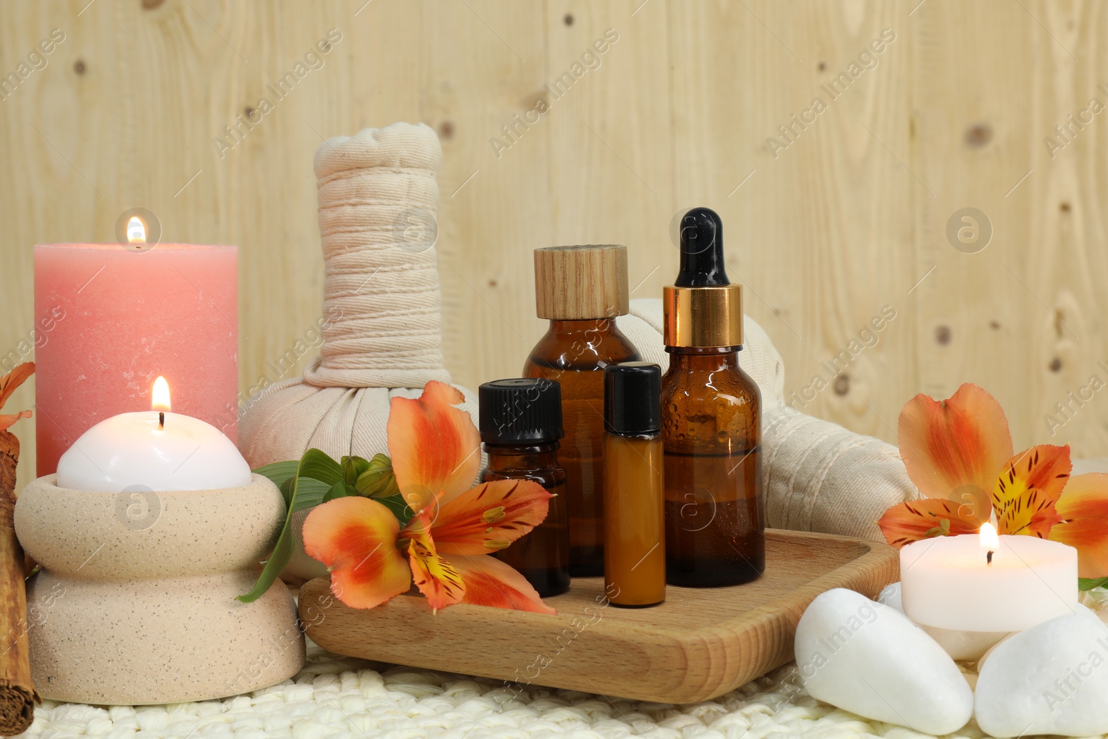 Photo of Different aromatherapy products and burning candles on table