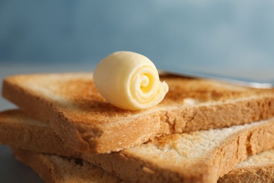 Toasted bread with fresh butter curl, closeup