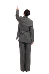 Businesswoman in suit pointing at something on white background, back view