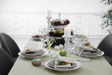 Photo of Beautiful Easter table setting with floral decor indoors