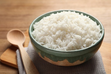 Bowl of tasty cooked rice served on table