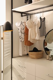 Photo of Closet interior with storage rack for clothes and accessories