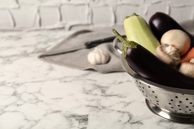 Fresh vegetables on white marble table, closeup. Space for text