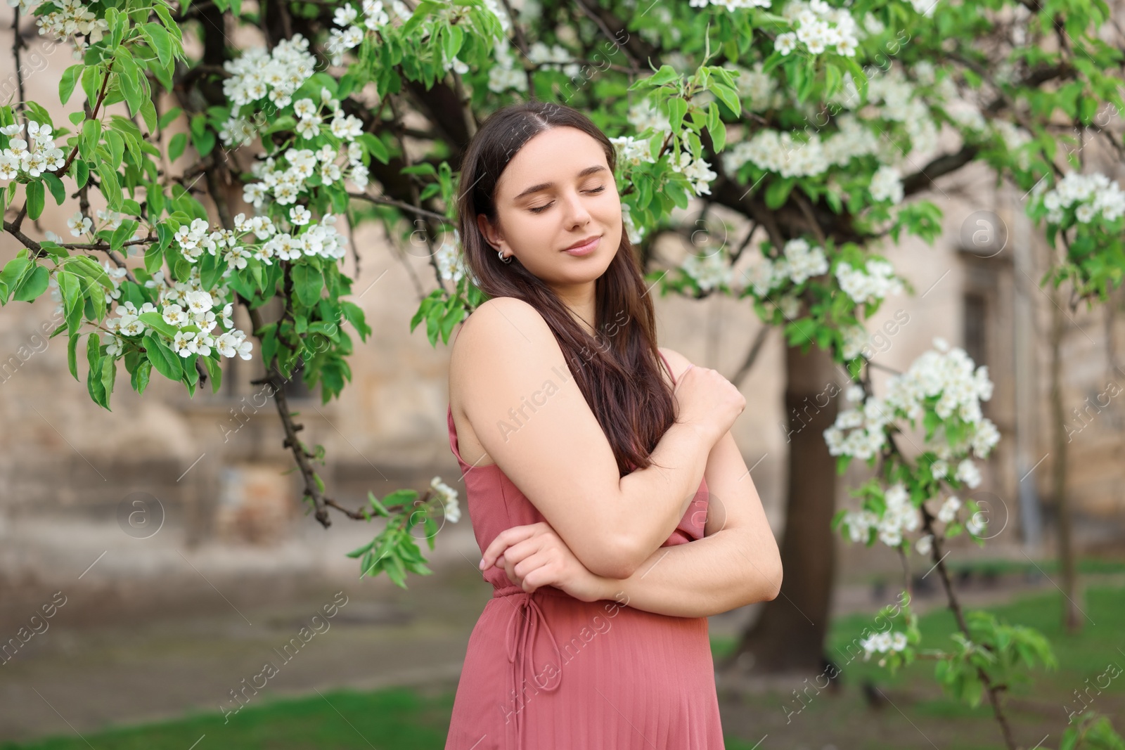 Photo of Beautiful woman near blossoming tree on spring day