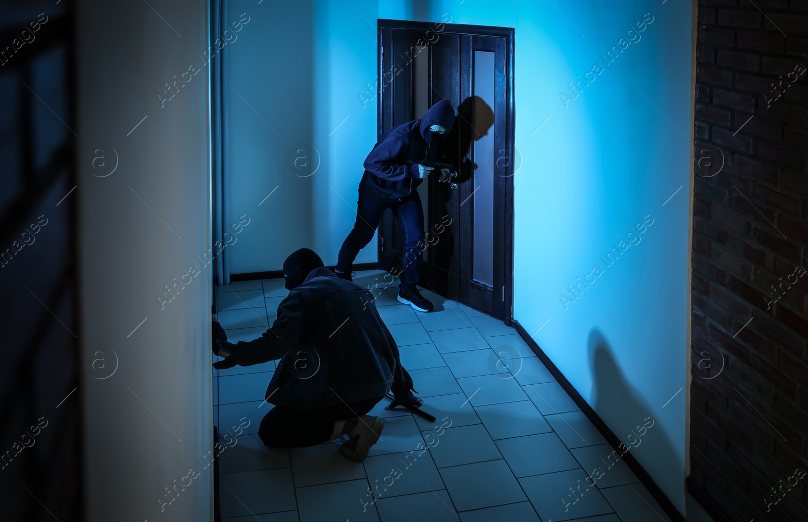 Photo of Dangerous criminals with gun and crow bar intruding into apartment