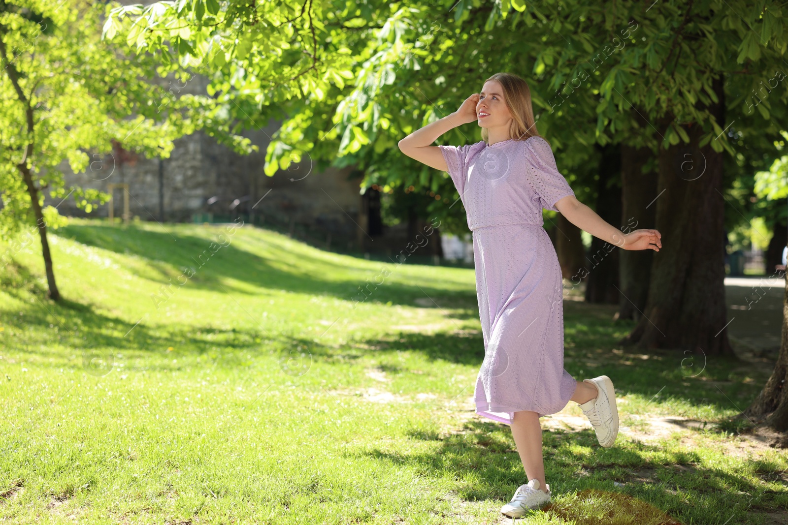 Photo of Beautiful woman in park, space for text. Spring sunny day