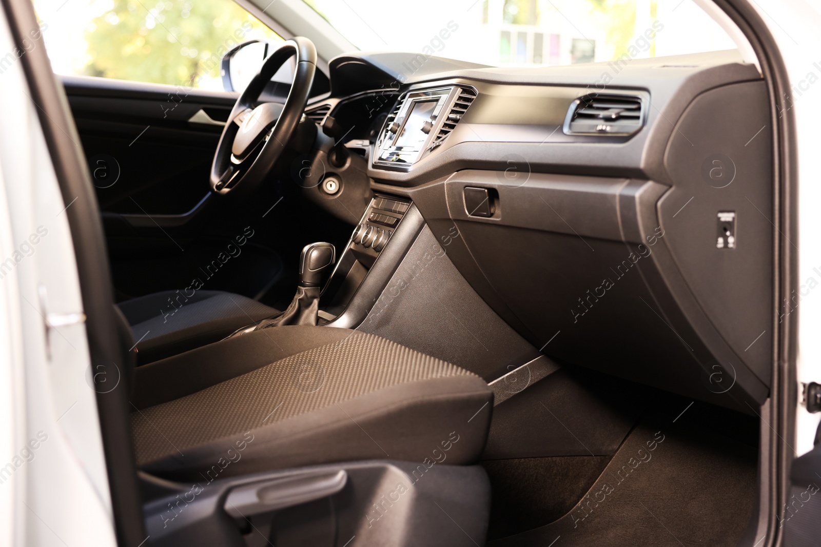 Photo of Stylish car interior with steering wheel and comfortable seats inside