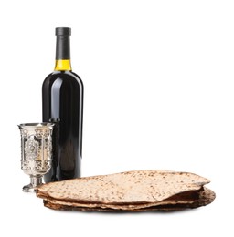 Photo of Tasty matzos, wine and goblet on white background. Passover (Pesach) celebration