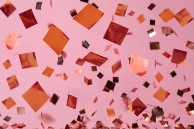 Image of Shiny confetti falling down on pink background