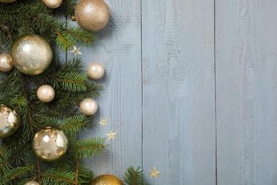 Fir branches with Christmas decoration on grey wooden background, flat lay. Space for text