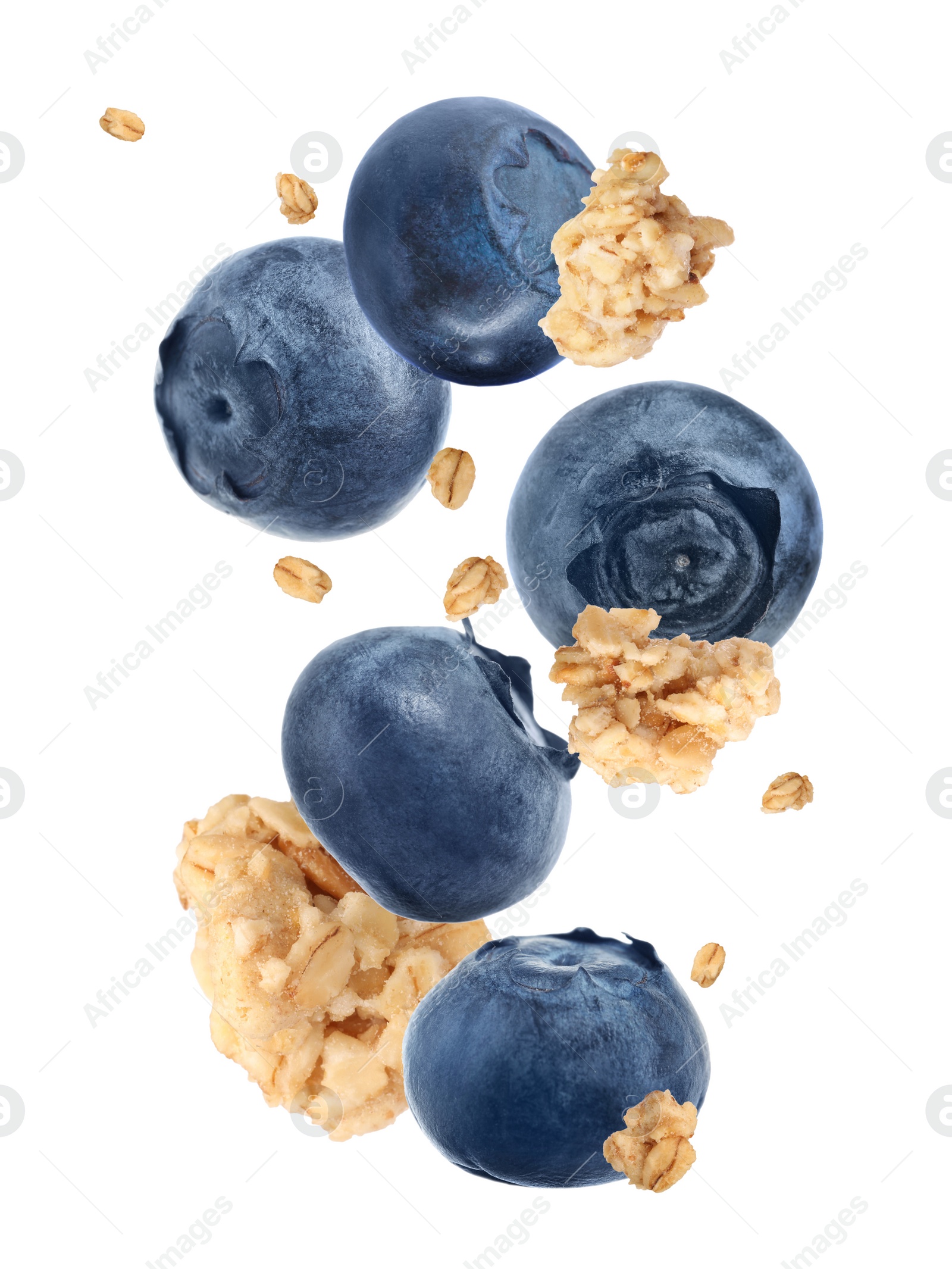 Image of Delicious granola and blueberries falling on white background. Healthy snack  