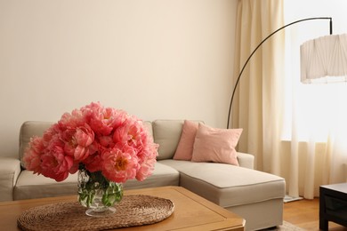 Photo of Beautiful pink peonies in vase on table at home, space for text. Interior design