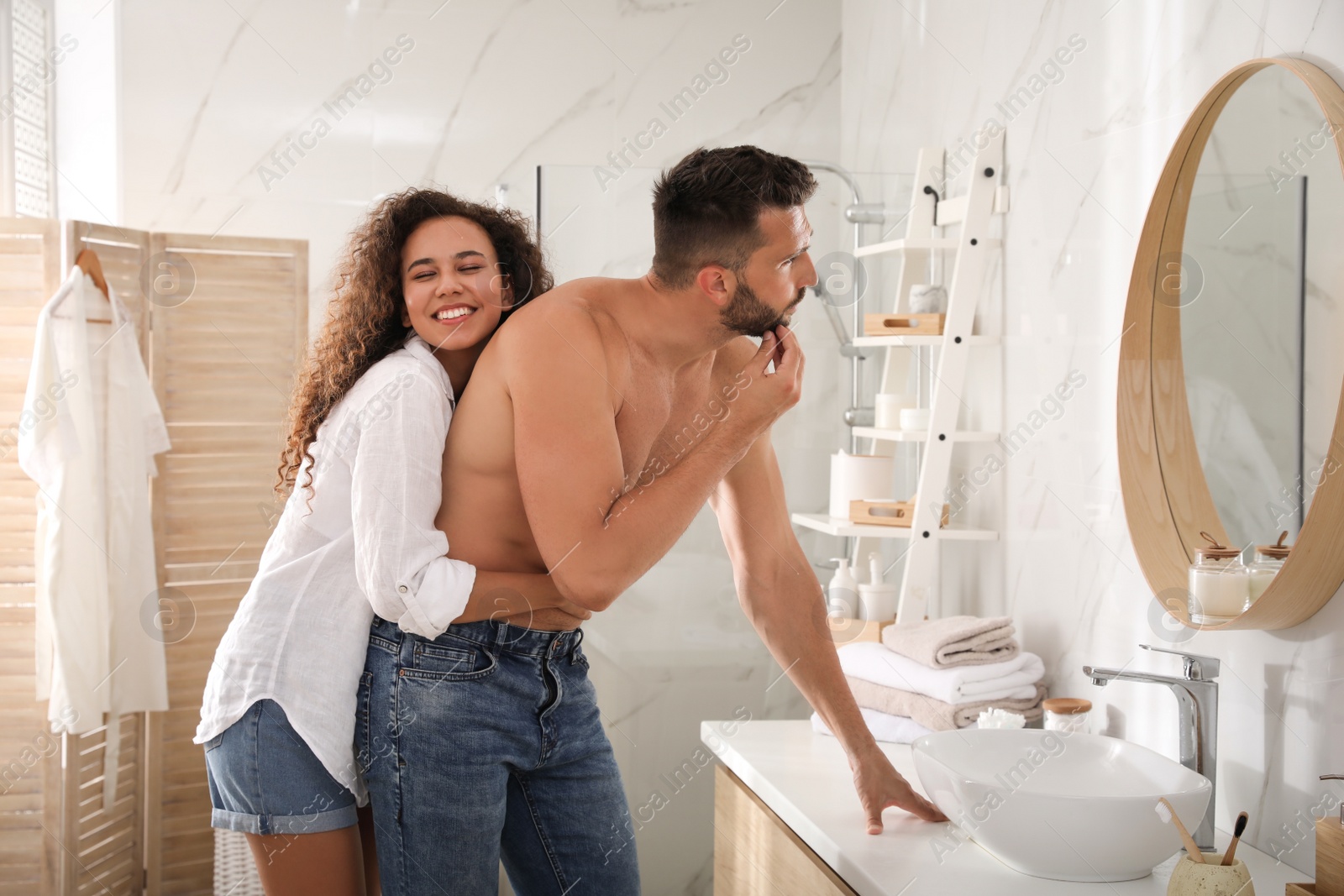 Photo of Lovely couple enjoying each other in bathroom at home