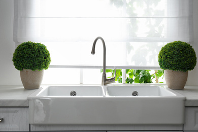 Photo of Modern double bowl sink near window in kitchen