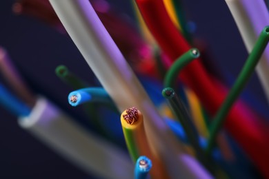 Photo of Colorful cables on blurred background, closeup. Electrician's supply