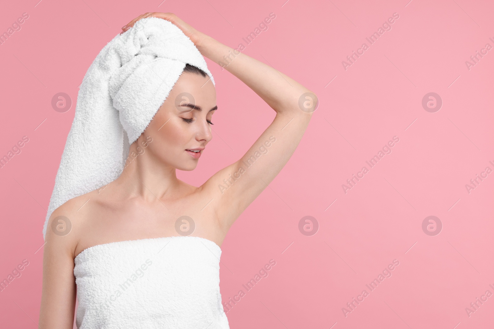 Photo of Beautiful woman showing armpit with smooth clean skin on pink background, space for text