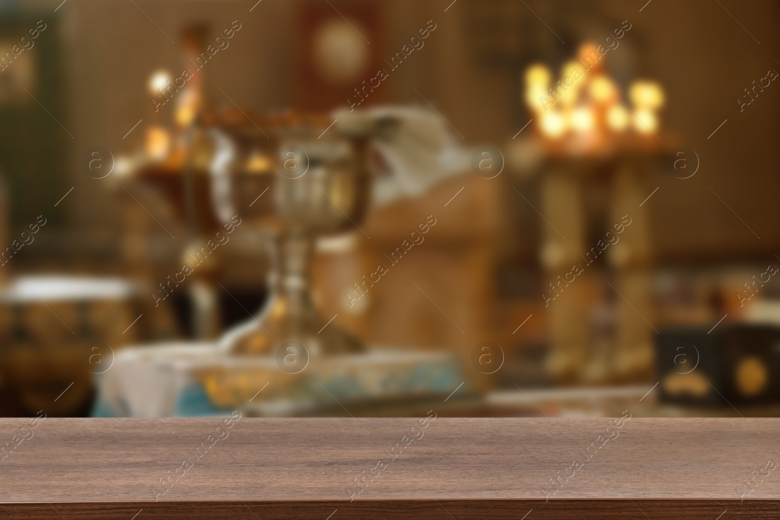 Image of Empty wooden table and blurred view of beautiful church interior, space for text