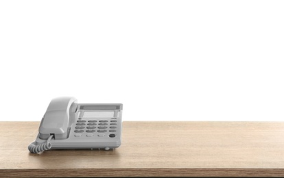 Telephone on wooden table against white background