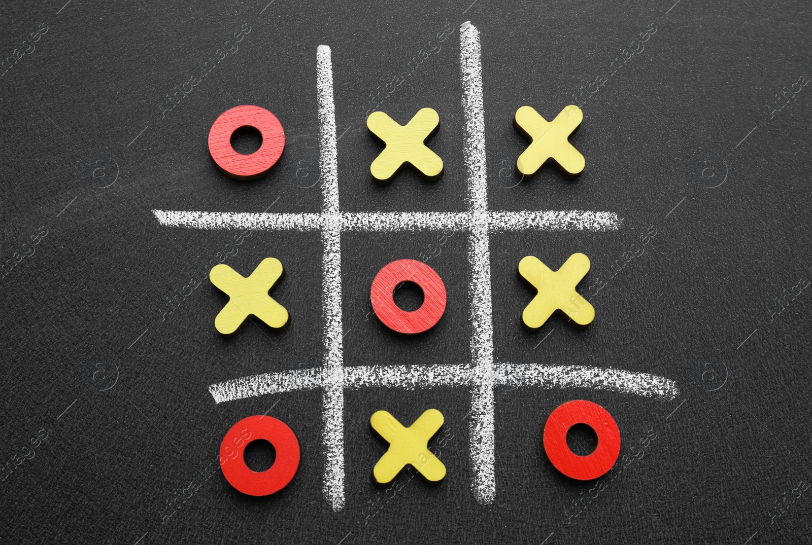 Photo of Tic tac toe game on blackboard, flat lay