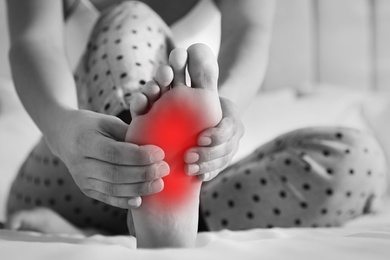 Image of Woman suffering from foot pain at home, closeup