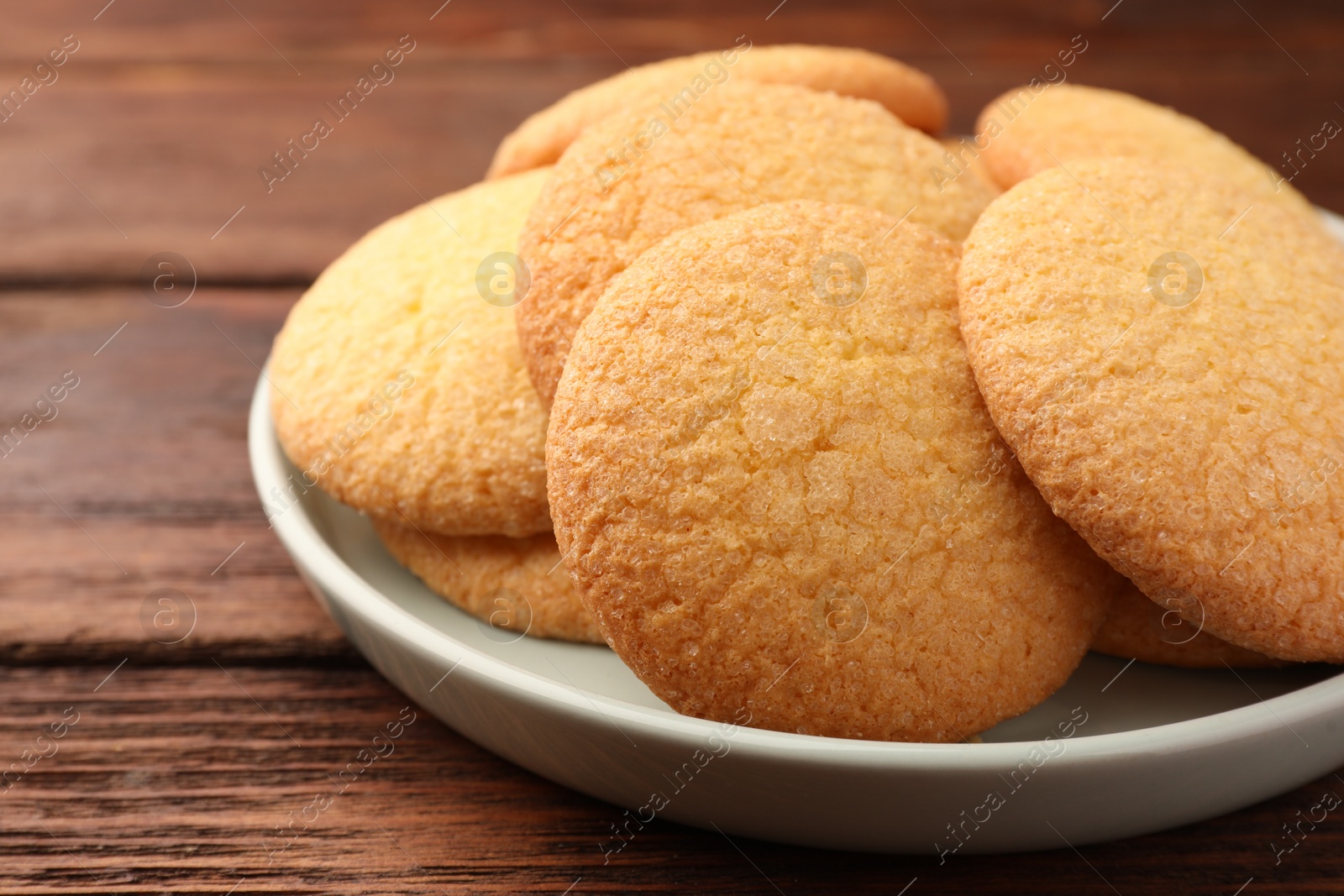 Photo of Delicious Danish butter cookies on wooden table, closeup