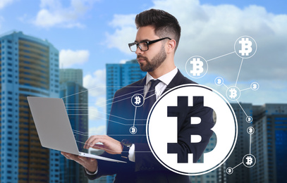 Image of Fintech concept. Scheme with bitcoin symbols and businessman using laptop on cityscape background