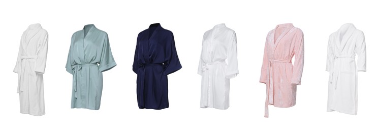 Set of different bathrobes on white background