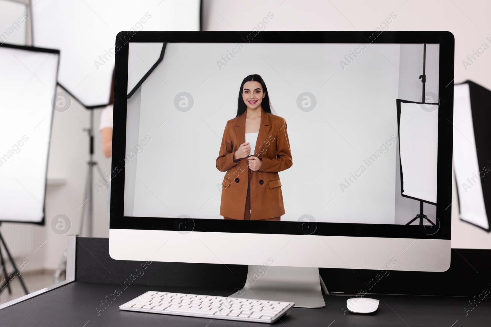 Photo of Picture of beautiful model on computer screen in professional photo studio