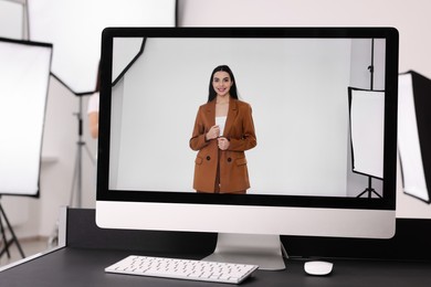 Picture of beautiful model on computer screen in professional photo studio