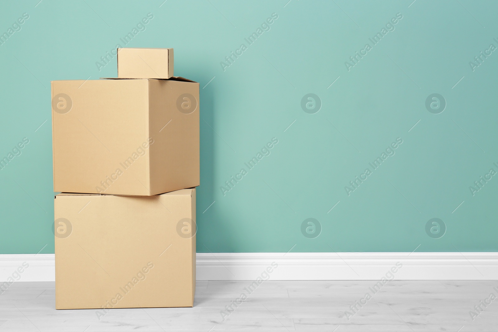 Photo of Cardboard boxes near color wall