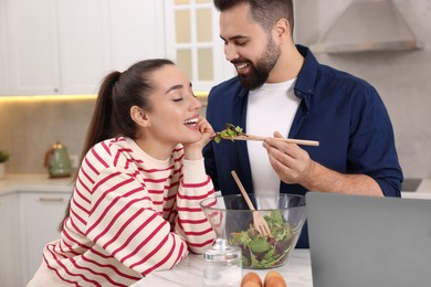 Photo of Happy lovely couple cooking together in kitchen