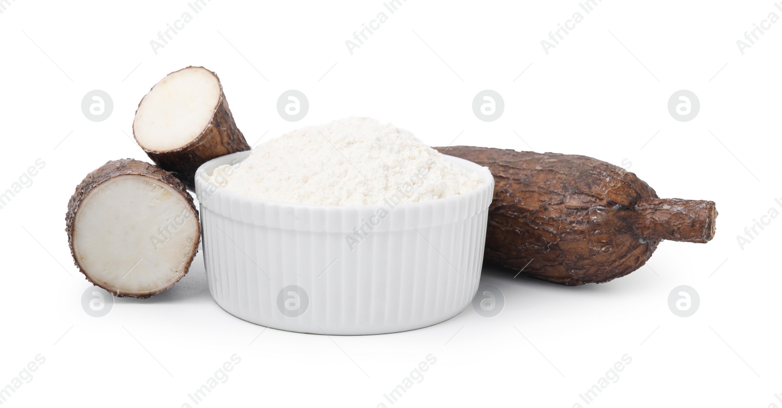 Photo of Bowl with cassava flour and roots isolated on white