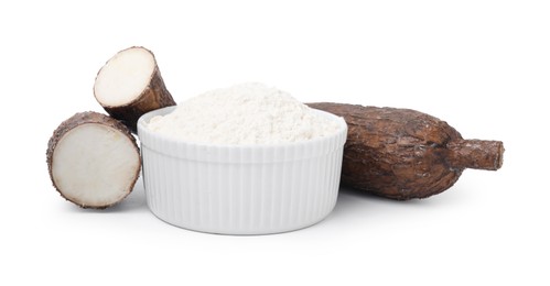 Photo of Bowl with cassava flour and roots isolated on white