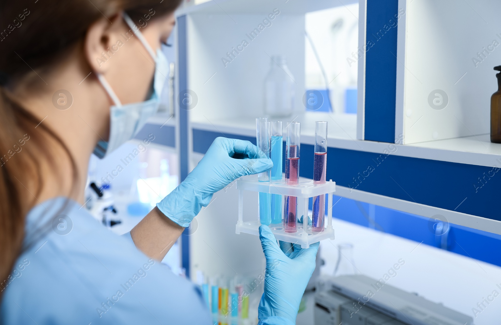 Photo of Scientist putting test tube in rack, closeup. Laboratory analysis