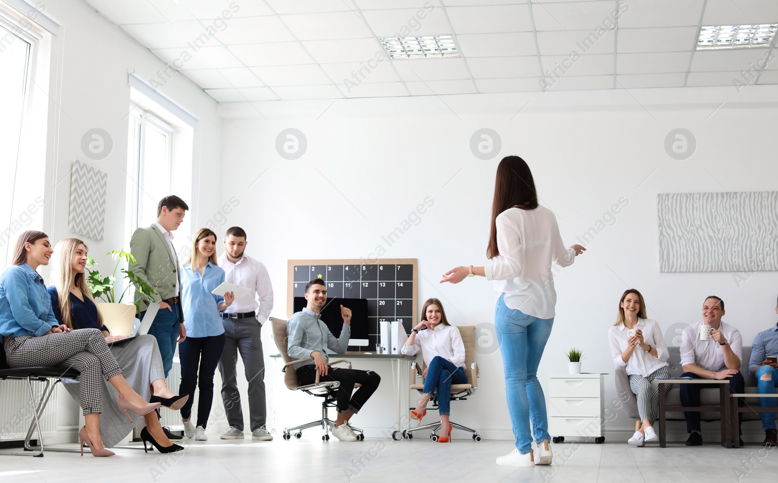 Photo of Female business trainer giving lecture in office