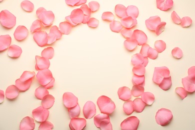 Photo of Beautiful pink rose flower petals on beige background, flat lay. Space for text