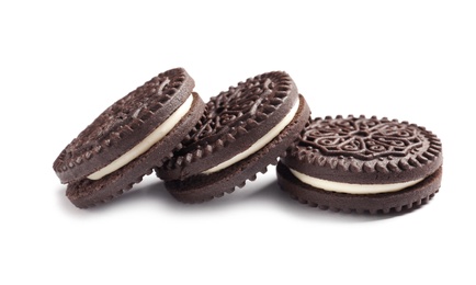 Photo of Tasty chocolate cookies with cream on white background