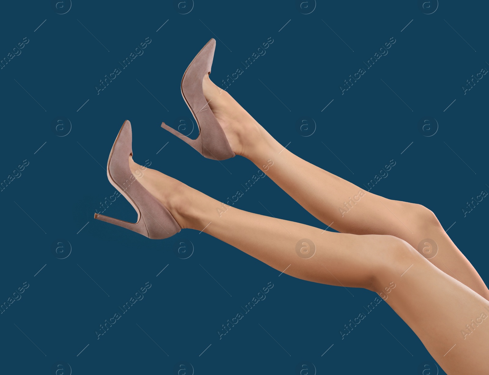 Photo of Woman in elegant shoes on dark blue background