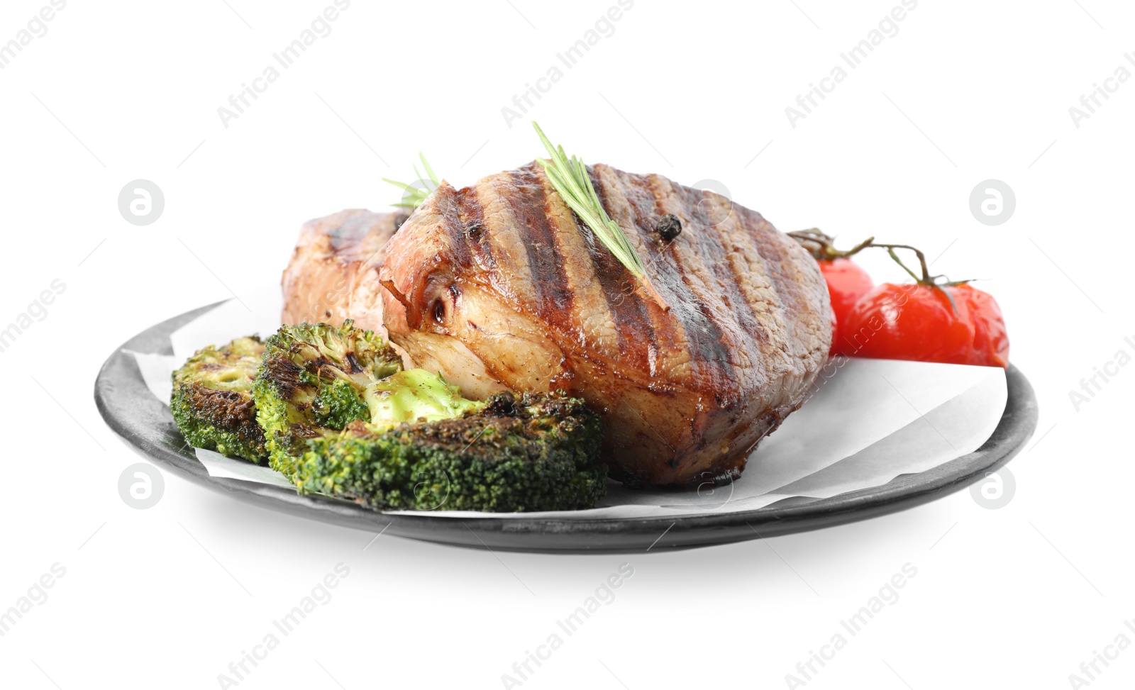 Photo of Delicious beef medallions served with vegetables isolated on white