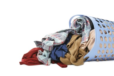 Photo of Overturned laundry basket full of clothes on white background, closeup