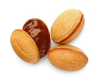 Photo of Delicious nut shaped cookies with boiled condensed milk on white background, top view