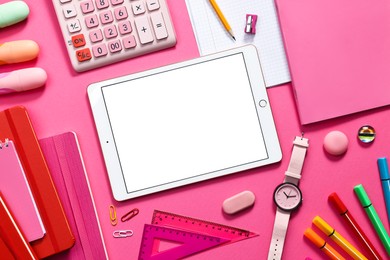 Photo of Modern tablet, calculator and stationery on pink background, flat lay. Space for text