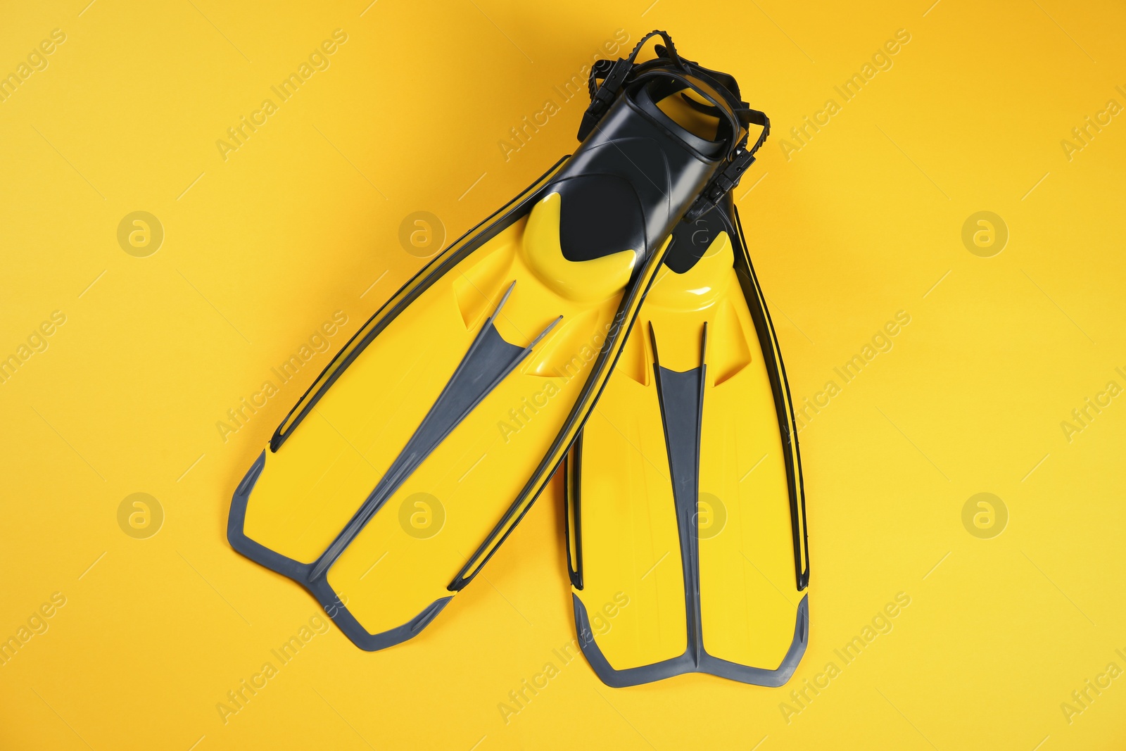 Photo of Swimming flippers on color background, top view