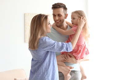 Young pregnant woman with her family at home